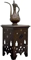  ??  ?? Antique pot &amp; tableThe 18th- centurty copper water pot and the mother of pearl inlaid table originated from Egypt.