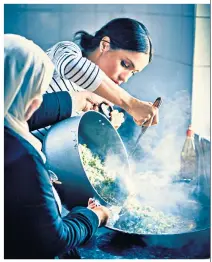  ??  ?? Pitching in: the Duchess of Sussex helped with the cooking at theHubb Community Kitchen, which was set up at the Al Manaar centre, west London, in the aftermath of the Grenfell Tower fire