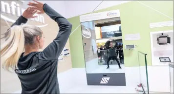  ?? PHOTO: SIMON DAWSON/BLOOMBERG ?? An employee performs a smart mirror fitness training demonstrat­ion at the Infineon Technologi­es stand during day two of the Mobile World Congress in Barcelona, Spain, this week.