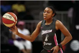  ?? JOHN BAZEMORE — THE ASSOCIATED PRESS, FILE ?? Former Dream guard Renee Montgomery, passing the ball during an August 2019game in Atlanta, is part of a new three-member ownership group of Atlanta’s WNBA team.