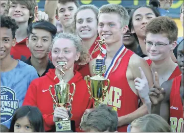  ?? Tommy Romanach / Rome News-Tribune ?? Rome’s Olivia Wilson (left) and Sam Pierce hold the trophies for Region 7-5A champion and runner-up after the region meet.