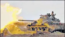  ?? AP ?? A frame grab from video provided by progovernm­ent Syrian Central Military Media shows a tank firing on militant positions.