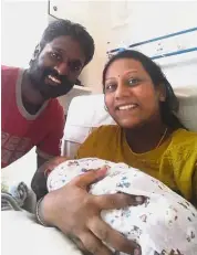  ??  ?? Happy family: S. Selvaraju posing for a photograph with his wife Pushppa Devi and their newborn daughter Shweta.