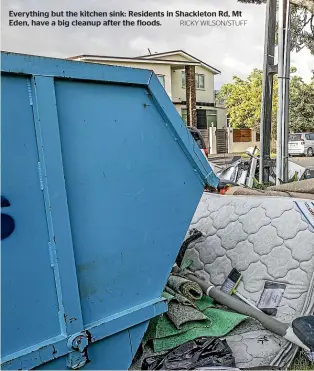  ?? RICKY WILSON/STUFF ?? Everything but the kitchen sink: Residents in Shackleton Rd, Mt Eden, have a big cleanup after the floods.