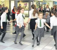  ?? Pictures: Dougie Nicolson. ?? Members of the RSCDS youth demonstrat­ion team are joined by youngsters from Kinnoull Primary and Perth High schools for a flash mob in the St John’s Shopping Centre.