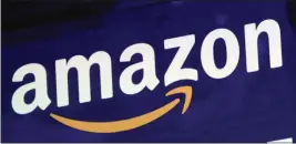  ?? RICHARD DREW — THE ASSOCIATED PRESS FILE ?? The logo for Amazon is displayed on a screen at the Nasdaq MarketSite in New York.