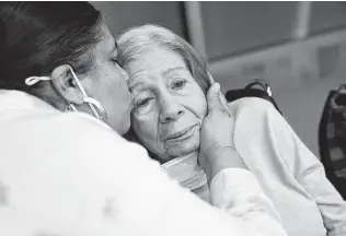  ?? Associated Press file photo ?? Rosa DeSoto, left, embraces her 93-year-old mother, Gloria, who suffers from dementia, inside the Hebrew Home at Riverdale in New York City in March.