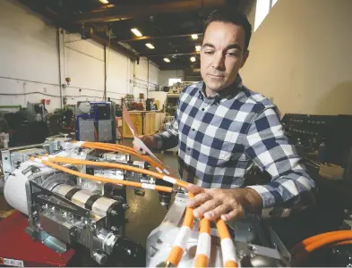  ?? PIERRE OBENDRAUF / MONTREAL GAZETTE FILES ?? Effenco CEO David Arsenault gets a last look at electric motors to be shipped to France from their Montreal plant earlier this week. Business is still good despite COVID-19 and the company is adding another 25 staff.