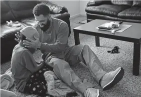  ?? Joe Amon, Denver Post file ?? Rene LimaMarín plays with his youngest son Josiah “JoJo” at his brother-inlaw’s house after he is set free in 2018 from an Aurora ICE detention facility.