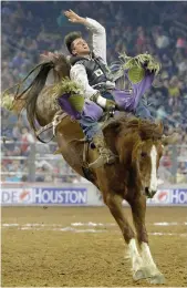  ?? Melissa Phillip / Houston Chronicle ?? Caleb Bennett of Tremonton, Utah, competes in bareback riding at RodeoHoust­on.