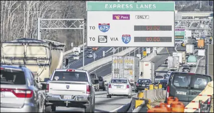  ?? JOHN SPINK PHOTOS /JSPINK@AJC.COM ?? The Express Lanes toll sign just north of Ga. 20 in McDonough showed no charge as the new I-75 South Metro Express Lanes had their first rush hour test Monday morning. The lanes opened Saturday. The two toll lanes are reversible — they’ll carry...