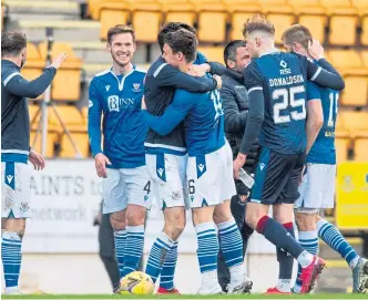  ??  ?? Saints players celebrate clinching their top six spot after beating Ross County.