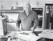  ??  ?? Keith Leydon shows his research materials for his book on the unsolved murders of James Barclay and John Bamford.