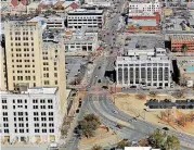  ?? THE OKLAHOMAN] [PHOTO BY JIM BECKEL, ?? Pioneer Park, shown center bottom of this photo, is set for a makeover by developers of the neighborin­g Pioneer Building (shown to the left).