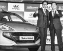  ?? PHOTO: SANJAY K SHARMA ?? Hyundai Motor India MD &amp; CEO Y K Koo ( right) with Bollywood actor and company ambassador Shah Rukh Khan at the launch of the new Santro in New Delhi on Tuesday