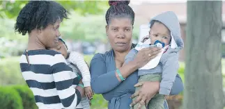  ?? GRAHAM HUGHES FOR NATIONAL POST ?? Asylum seekers Nadege Thomas with Jayden, left, and Marie with Joshua at the NAV Centre in Cornwall, Ont., on Wednesday.