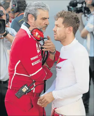  ?? Picture: AFP ?? GETTING INSIDE TAKE: Ferrari’s team chief Maurizio Arrivabene, left, speaks with their German driver Sebastian Vettel in the pits during a temporary halt in the Formula One Azerbaijan Grand Prix at the Baku City Circuit in Baku on Sunday