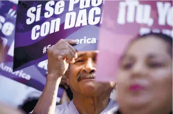  ?? (AP FOTO) ?? THEY ARE STILL HOPING. A man stands among signs during a rally in support of President Barack Obama’s plan to protect more than four million people living illegally in the United States from deportatio­n in San Diego. Immigrant expressed disappoint­ment...