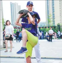  ?? PROVIDED TO CHINA DAILY ?? A youngster winds up for a pitch at the MLB Experience carnival in Beijing on Saturday.