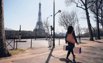  ?? THIBAULT CAMUS/AP 2020 ?? France believes its language is under attack. Above, a woman near the Eiffel Tower in Paris.