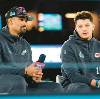  ?? MATT YORK/AP ?? Jalen Hurts and Patrick Mahomes, right, speak to the media during Super Bowl opening night Monday in Phoenix. Hurts and Mahomes will be the first two Black quarterbac­ks to face off in the Super Bowl when the Eagles and Chiefs play Sunday. The 27-year-old Mahomes can become the first Black QB to win the Super Bowl twice. He led the Chiefs to a 31-20 victory over the 49ers at the end of the 2019 season.