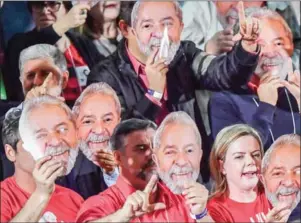  ?? AFP ?? Supporters hold masks depicting former president of Brazil Luiz Inacio Lula da Silva at a Workers Party convention in Sao Paulo on Saturday.