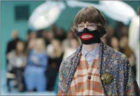  ?? ANTONIO CALANNI—ASSOCIATED PRESS ?? In this Feb. 21, 2018, file photo, a model wears a creation as part of the Gucci women’s Fall/Winter 2018-2019collec­tion, presented during the Milan Fashion Week, in Milan, Italy. Italian fashion designer Gucci is announcing a major push to step up its diversity hiring following an uproar over an $890sweater that resembled blackface, Friday, Feb. 15, 2019. The company also says it will hire a global director for diversity and inclusion, a newly created role. Gucci also is promising to launch a scholarshi­p program to cultivate diverse design talent.