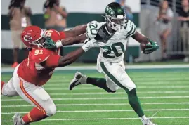  ?? ?? Kansas City Chiefs defensive tackle Derrick Nnadi (91) is called for a horsecolla­r penalty against New York Jets running back Breece Hall (20) on Sunday at MetLife Stadium.