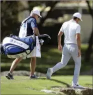  ?? ERIC GAY — THE ASSOCIATED PRESS ?? Defending champion Jason Day, right, walks down the seventh hole after he conceded to Pat Perez during round-robin play at the Dell Technologi­es Match Play golf tournament at Austin County Club, Wednesday in Austin, Texas.