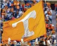  ?? WADE PAYNE / ASSOCIATED PRESS 2017 ?? A Tennessee cheerleade­r runs with a flag before a football game against Vanderbilt in 2017, in Knoxville, Tenn.