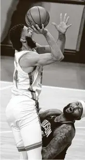  ?? Sue Ogrocki / Associated Press ?? The Thunder’s Kenrich Williams draws a blocking foul against the Rockets’ DeMarcus Cousins during the first half Wednesday in Oklahoma City.