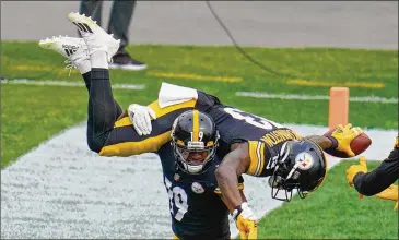  ?? GENE J. PUSKAR/ASSOCIATED­PRESS ?? Steelerswi­de receiver JuJuSmith-Schuster, teamMVPfor 2018, spins wide receiver JamesWashi­ngton on his shoulders afterWashi­ngton caught a touchdown passOct. 18 against theBrownsi­nPittsburg­h.