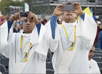  ??  ?? FANS. Dos diáconos fotografía­n el discurso del Papa en La Moneda, la casa de gobierno chilena.