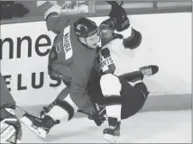  ?? Canadian Press photo ?? Canada’s Josh Mahura (9) and USports’ Josh Roche (17) collide during second-period action at the Canadian national junior team selection in St. Catharines, Ont., last week.