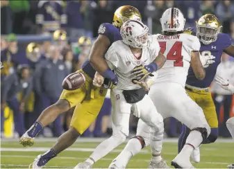  ?? Michael Hickey / Getty Images ?? Jerry Tillery gets one of his four sacks of Stanford quarterbac­k K.J. Costello on Saturday. Notre Dame had five sacks overall as the Irish rolled 38-17 over the Cardinal.