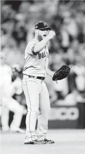  ?? ELSA/GETTY IMAGES ?? Red Sox reliever Craig Kimbrel celebrates after closing out a tense ninth inning as Boston defeated the Yankees, 4-3, on Tuesday night. The victory wrapped up the American League Division Series for Boston, which moves on to face the Houston Astros in the American League Championsh­ip Series. Details at baltimores­un.com/sports.