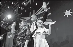  ?? TRACEY NEARMY/GETTY ?? Prime Minister Scott Morrison, flanked by his wife, Jenny, and daughters Abbey, 11, left, and Lily, 9, delivers his victory speech Saturday. He defeated Labor leader Bill Shorten.