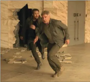  ??  ?? WARNER BROS. PICTURES Ryan Gosling, left, and Harrison Ford appear in a scene from “Blade Runner 2049.”