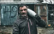  ?? Associated Press ?? A Ukrainian soldier carries a shell to fire at Russian positions Tuesday in Donetsk region, Ukraine.