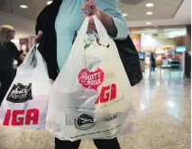  ?? RYAN REMIORZ/THE CANADIAN PRESS ?? Shopkeeper­s found violating the thin plastic bag ban face fines ranging from $200 to as high as $4,000.