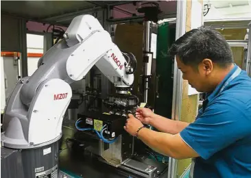  ??  ?? Record year: A worker at the MMSV Bayan Lepas plant checking out test equipment for the automotive and semiconduc­tor industries. It was a record year for MMSV in the FY17 when it more than doubled its revenue to RM75.57mil from RM35.58mil in the...