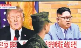  ?? AFP ?? A South Korean soldier watches a TV screen showing pictures of Trump and Kim.
