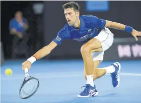  ?? (Photos: AFP) ?? Serbia’s Novak Djokovic hits a return against Russia’s Daniil Medvedev during their men’s singles match on day eight of the Australian Open tennis tournament in Melbourne yesterday.