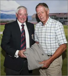  ??  ?? Veteran winner Richie Barry receives his prize from Dundalk President Noel McGuinness.