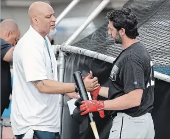  ?? CHRIS O'MEARA THE ASSOCIATED PRESS ?? Tony Clark, left, head of the Major League Baseball Players Associatio­n, shakes hands with free agent player and former Toronto Blue Jay Chris Colabello before an exhibition baseball game in Bradenton, Fla.