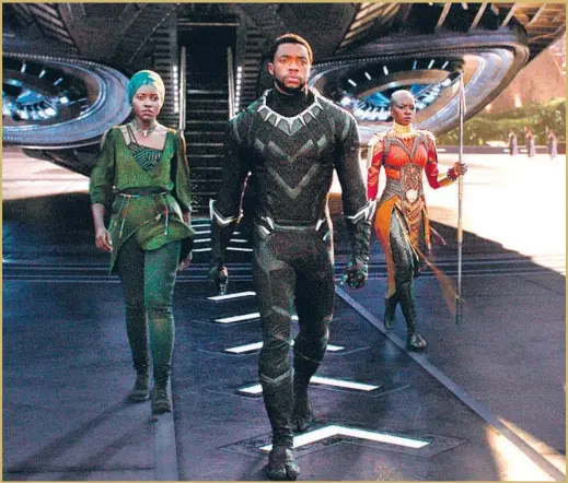  ?? Film Frame / Marvel Studios ?? “BLACK PANTHER,” with Lupita Nyong’o, left, Chadwick Boseman and Danai Gurira, transcends the typical superhero blockbuste­r, a Times critic writes.