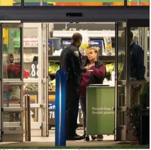  ?? (AP/Alex Brandon) ?? A Walmart employee speaks with law enforcemen­t officials Wednesday as they investigat­e the mass shooting at a Walmart in Chesapeake, Va. More photos at arkansason­line.com/1124chesap­eake/.