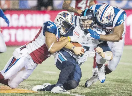  ?? GRAHAM HUGHES/THE CANADIAN PRESS ?? Toronto Argonauts quarterbac­k Cody Fajardo, centre, is sandwiched by the Alouettes’ John Bowman, left, and Kyries Hebert Aug. 11 during Montreal’s 21-9 victory at Molson Stadium. Hebert was fined the maximum amount allowable for a high hit on Fajardo.