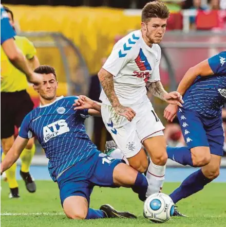  ?? EPA PIC ?? Rangers’ Josh Windass (centre) tries to dribble past Shkupi’s Ron Broja in a Europa League first qualifying round, second leg match in Skopje, Macedonia on Tuesday.