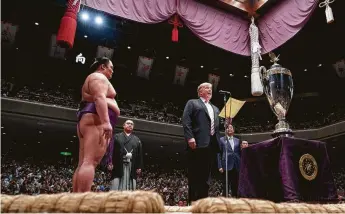  ?? Erin Schaff / New York Times ?? President Donald Trump prepares to present the United States President’s Cup to Tokyo Grand Sumo Tournament winner Asanoyama at the Ryogoku Kokugikan on Sunday.